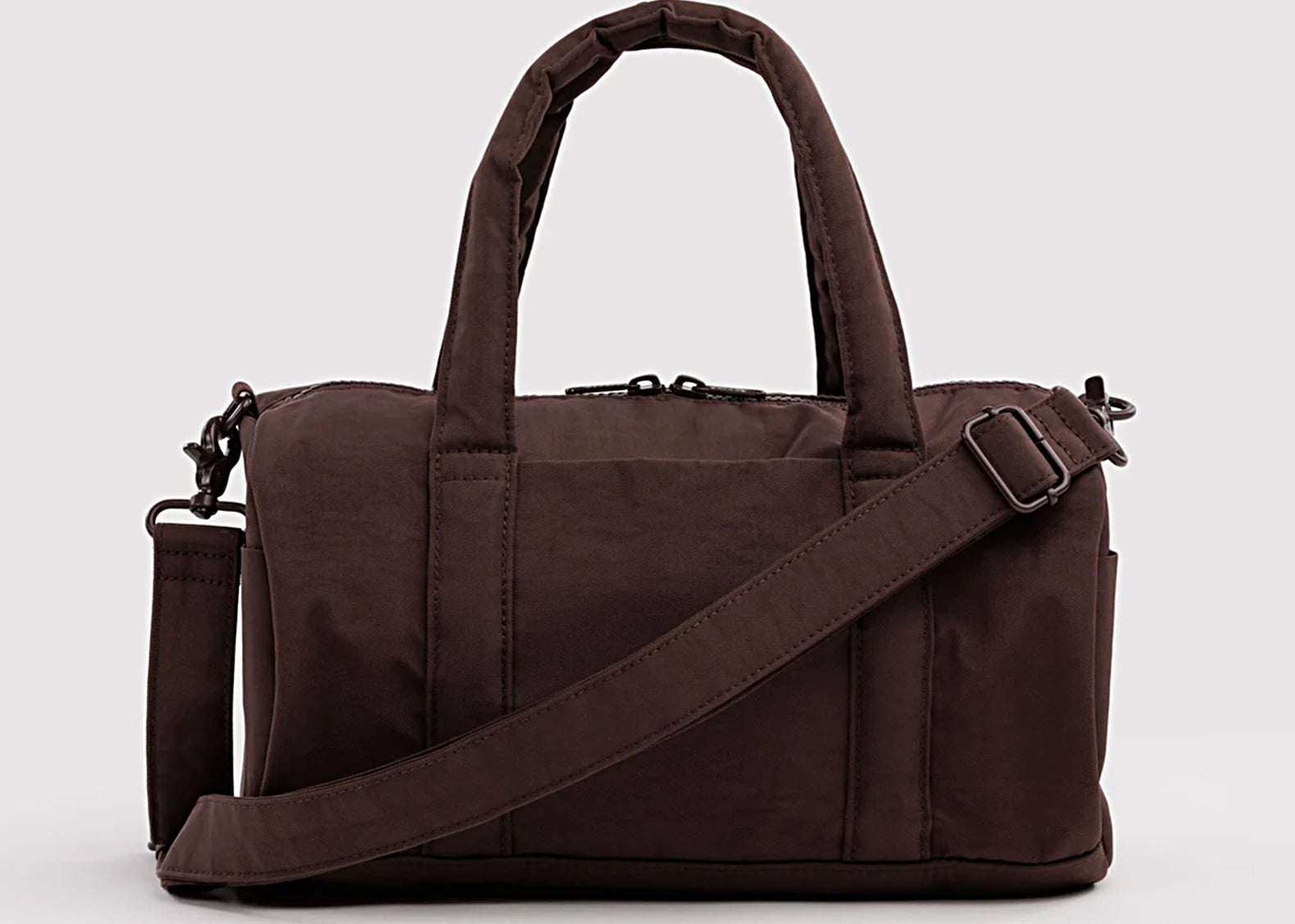 Front view of the chocolate brown Baggu duffle with padded handles and crossbody strap