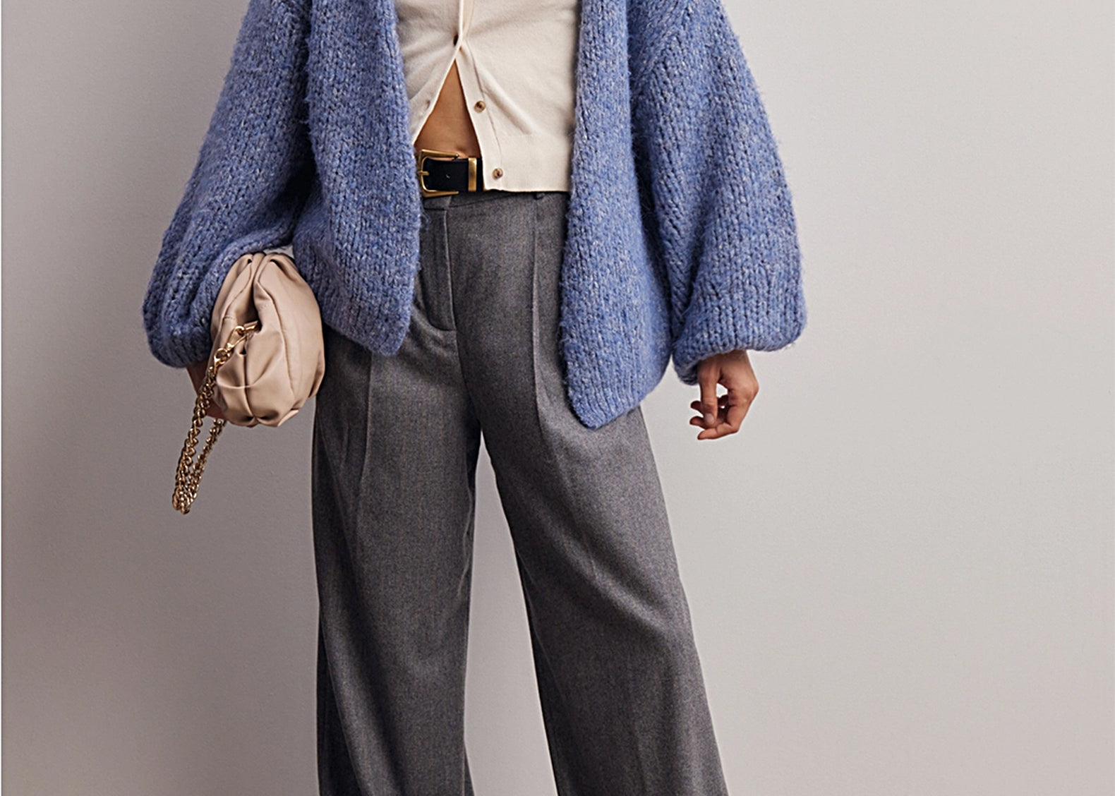 Full-length styled shot of the cornflower blue cardigan with gray wide-leg trousers