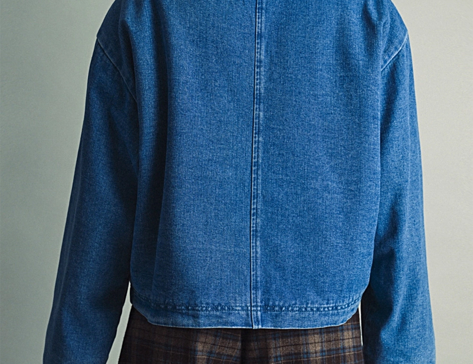 Back view of the Faye Toggle Button Sherpa + Denim Jacket with the sherpa collar and center back seam