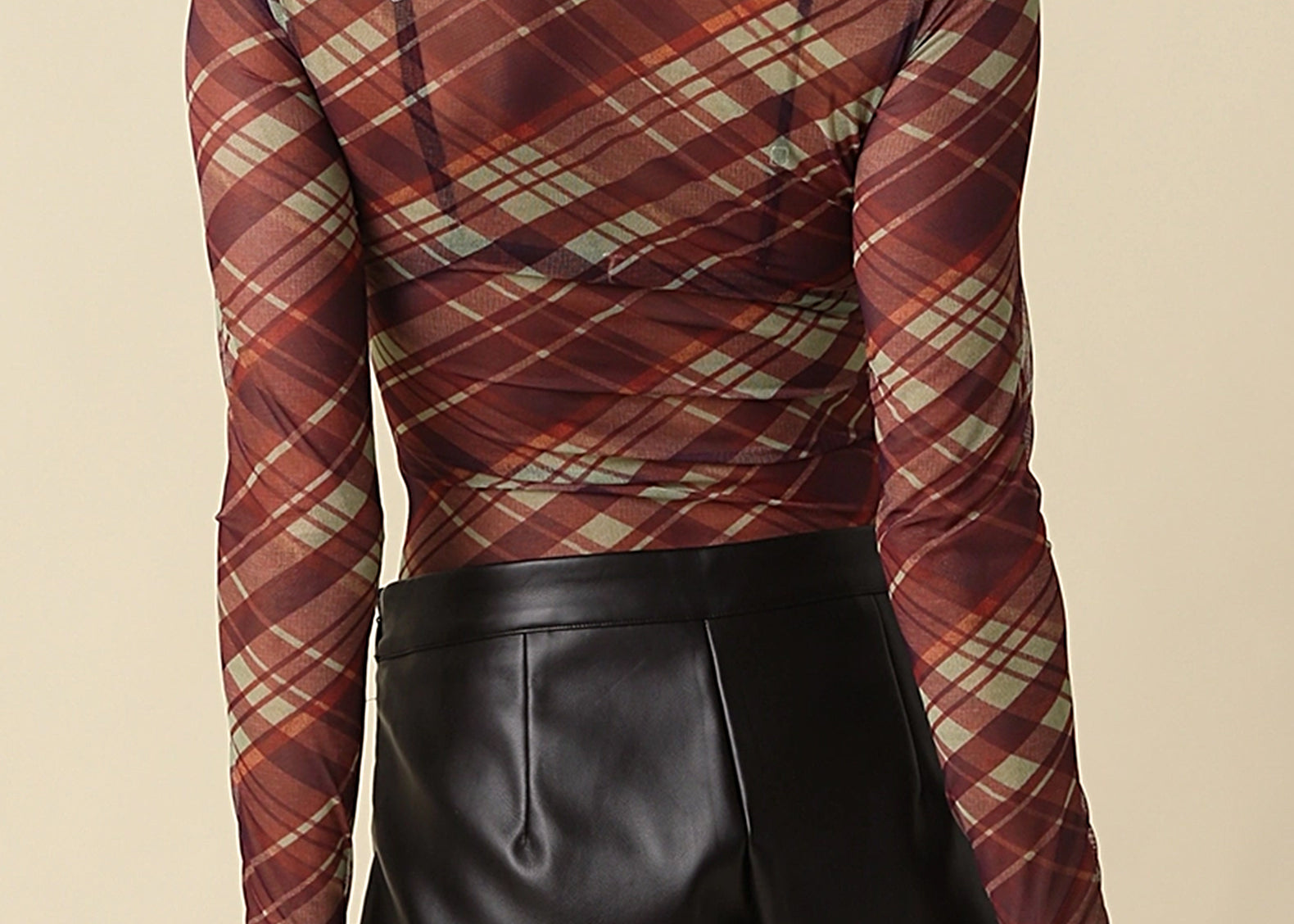 Back view of the Jackie Plaid Mesh Mock Neck Top showing the diagonal plaid print and fitted sleeves