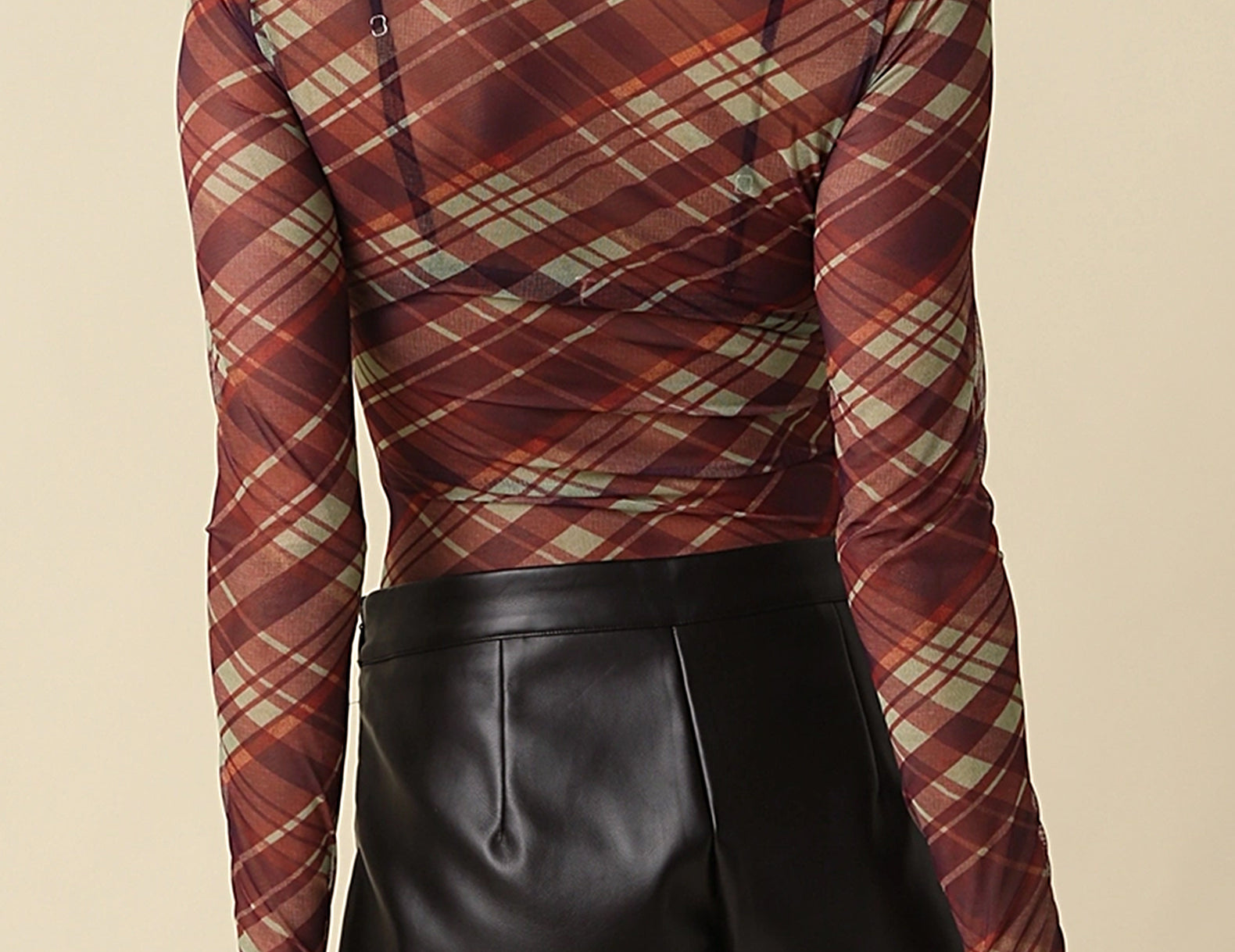 Back view of the Jackie Plaid Mesh Mock Neck Top showing the diagonal plaid print and fitted sleeves