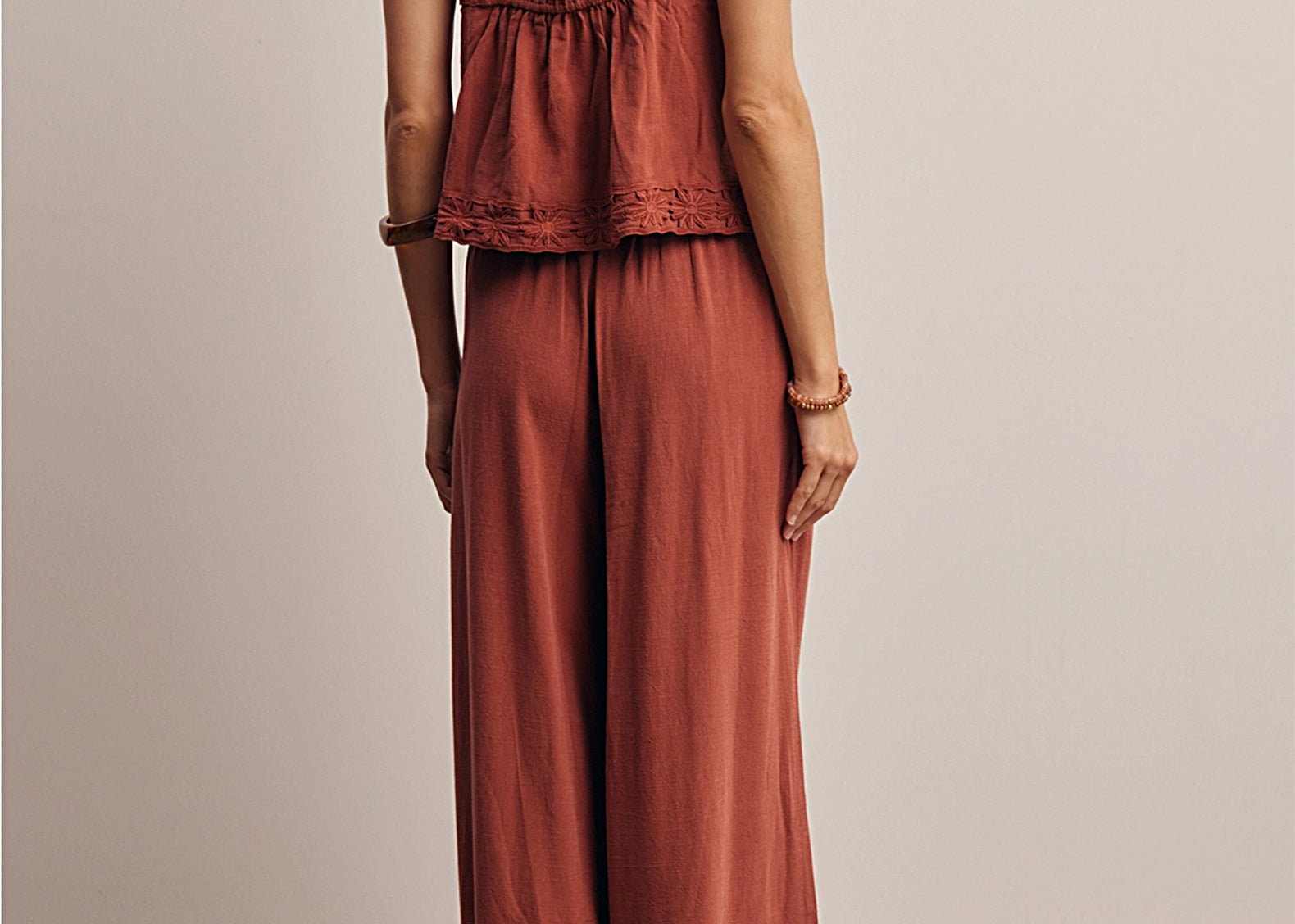 Back view of the Layla Embroidered Masala Pant showing the full wide leg and embroidered hem, worn with the matching tank