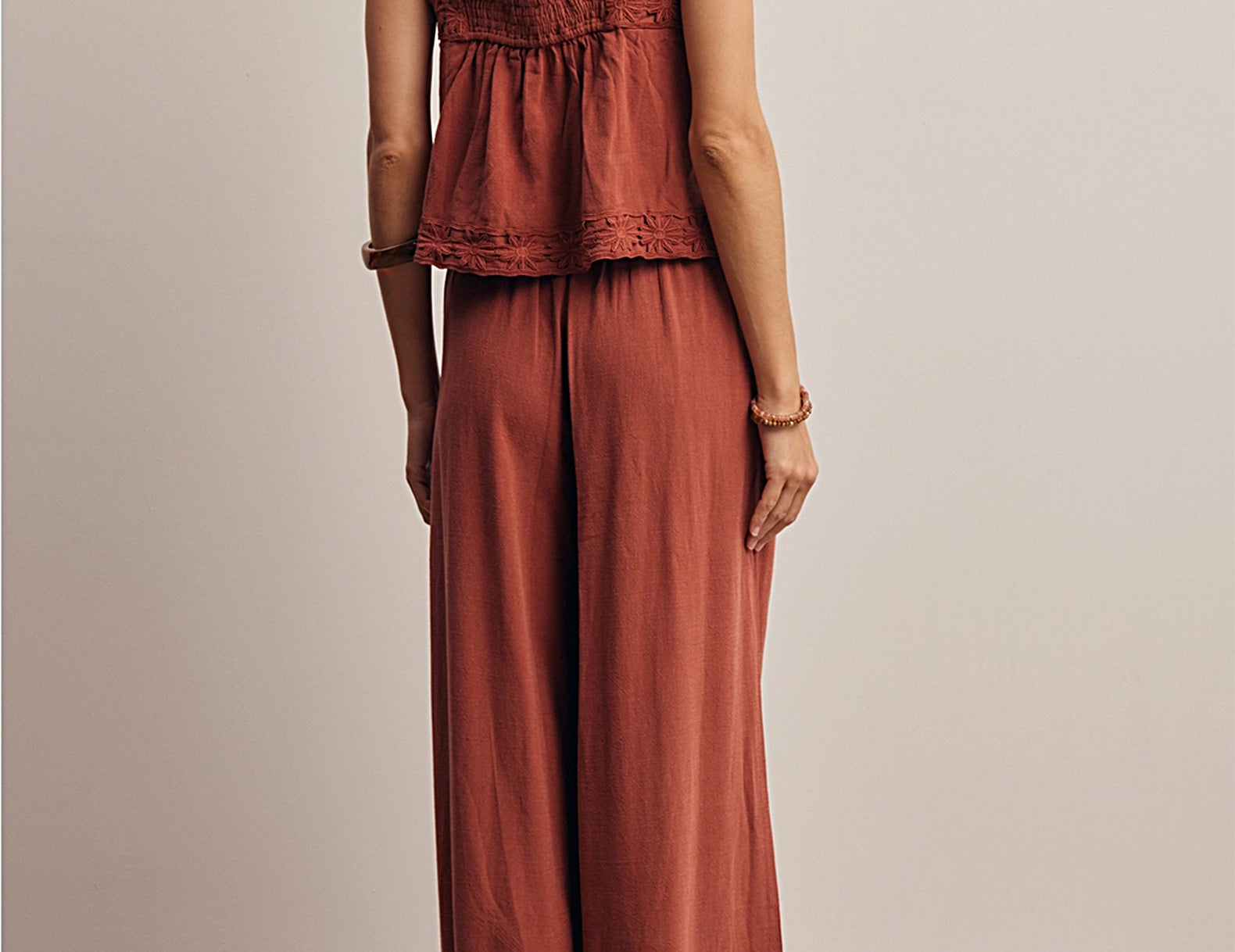 Back view of the Layla Embroidered Masala Pant showing the full wide leg and embroidered hem, worn with the matching tank