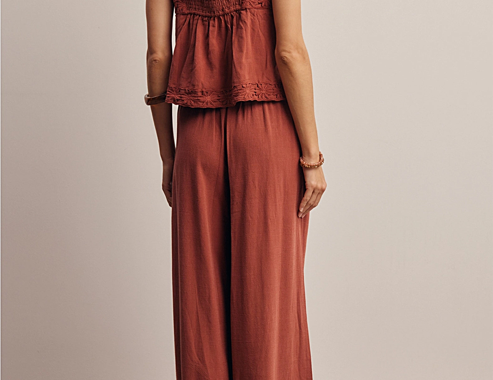 Back view of the Layla Embroidered Masala Tank Top showing the smocked back panel, square back and wide embroidered straps