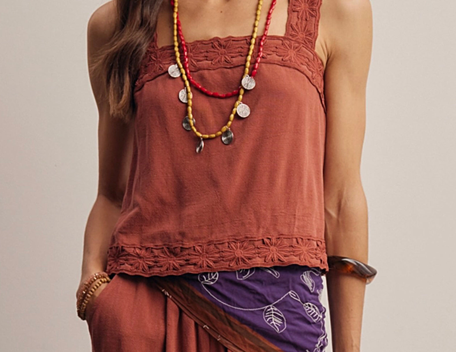 Close-up of the daisy embroidery along the square neckline and hem of the Layla masala tank