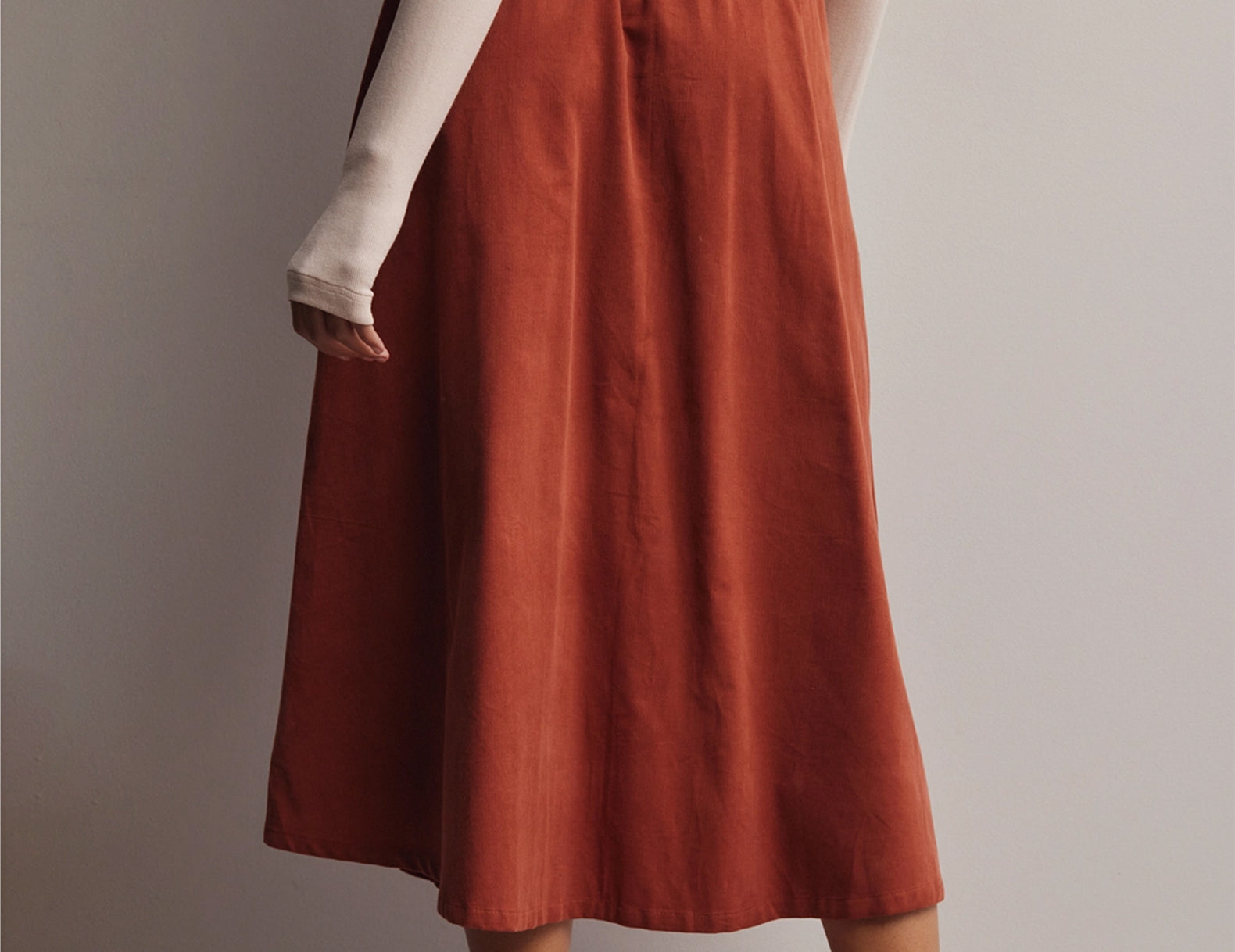 Back view of the terracotta Marnie corduroy skirt showing the elastic waistband and A-line shape