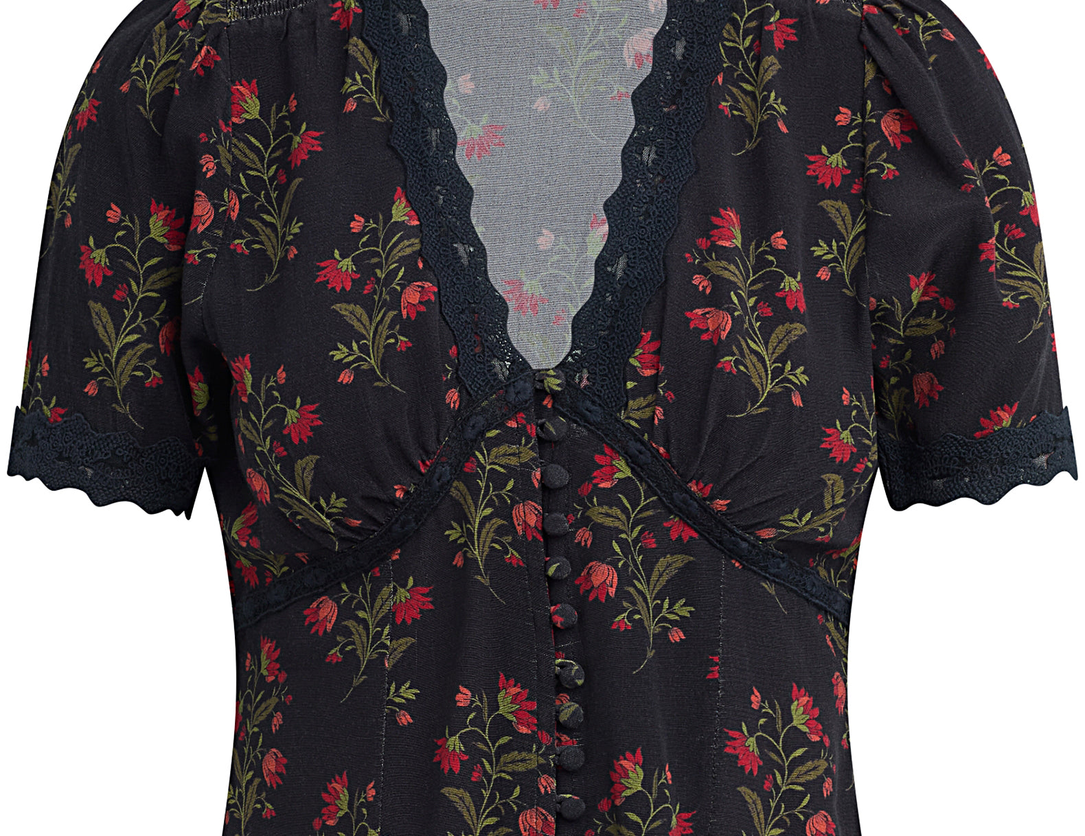A short-sleeve floral blouse by Kari Traa, featuring a black base with red and green floral patterns, a lace-trimmed V-neckline, and a button-down front.