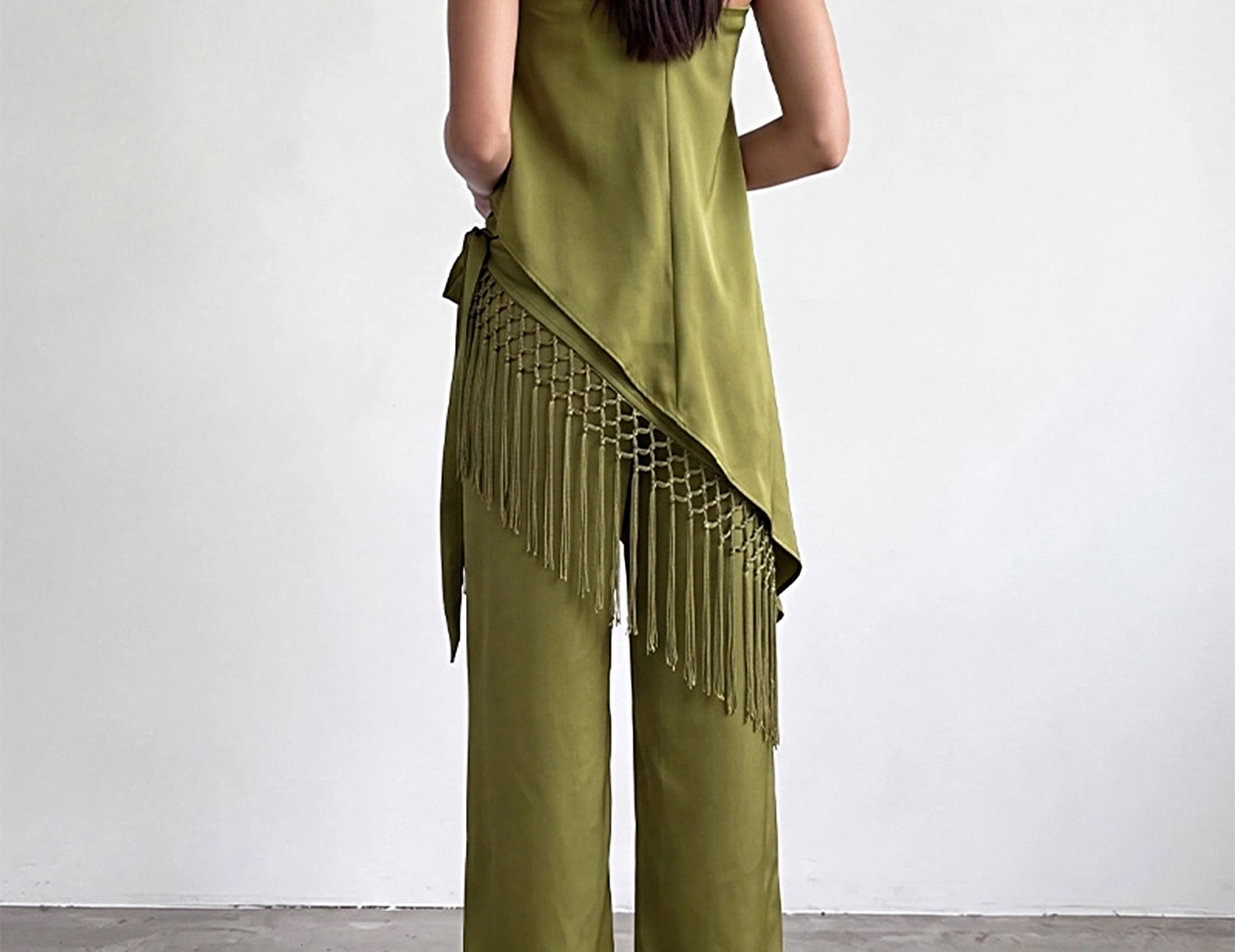 Back view of the olive satin wide-leg pants with fringe scarf