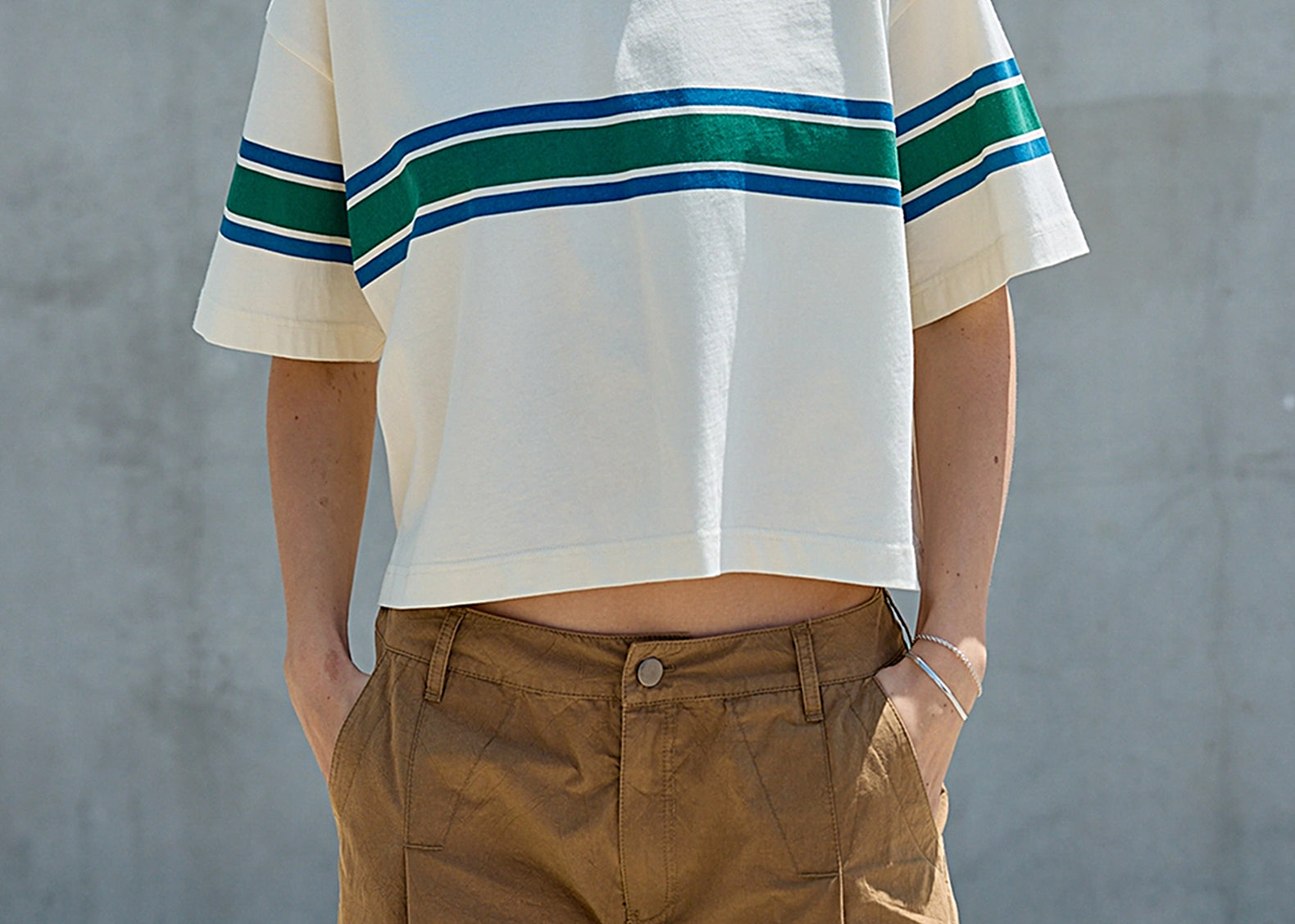 Front view of the cream boxy tee with dropped shoulders and cropped hem