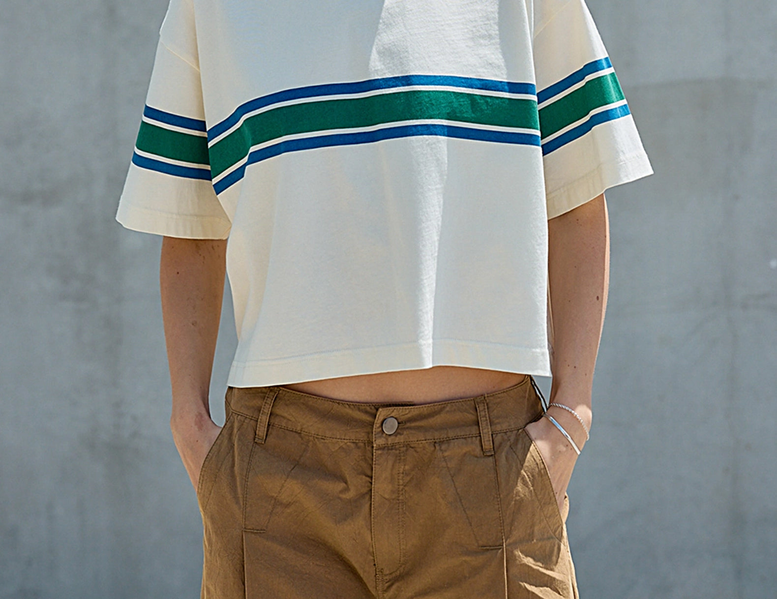 Front view of the cream boxy tee with dropped shoulders and cropped hem