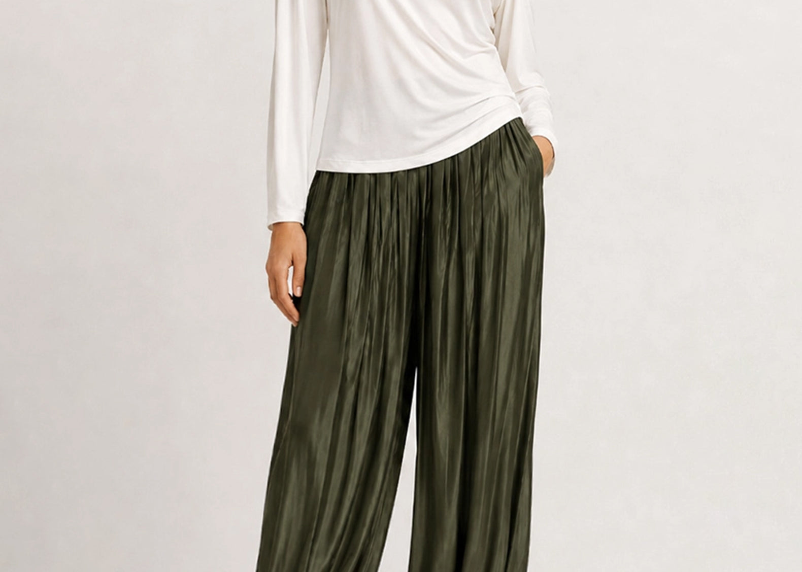 Full-length front view of the evergreen satin balloon pants with a white top