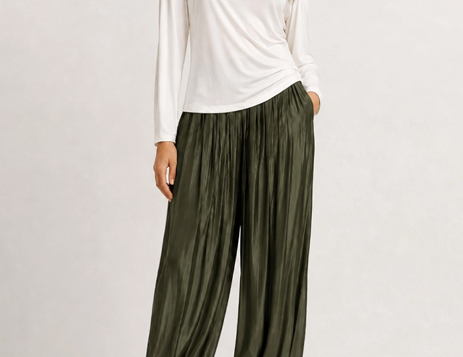 Full-length front view of the evergreen satin balloon pants with a white top