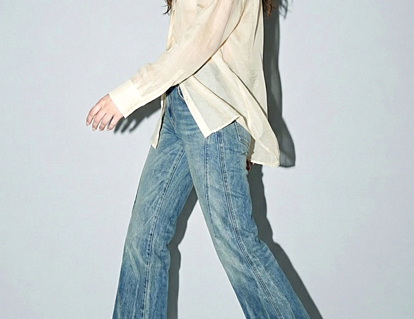 Side walking view of the oversized organza blouse with dropped shoulders