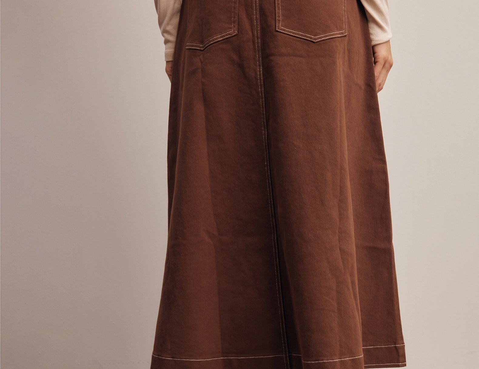 Back view of the Shilo Chocolate Utility Pocket Midi Skirt showing the elastic back waistband and patch pockets