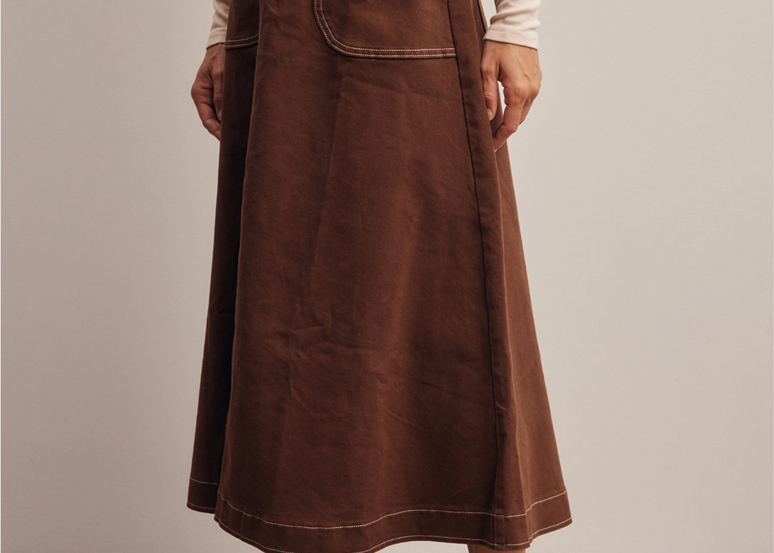 Side angle of the Shilo midi skirt showing the A-line flare and topstitched hem