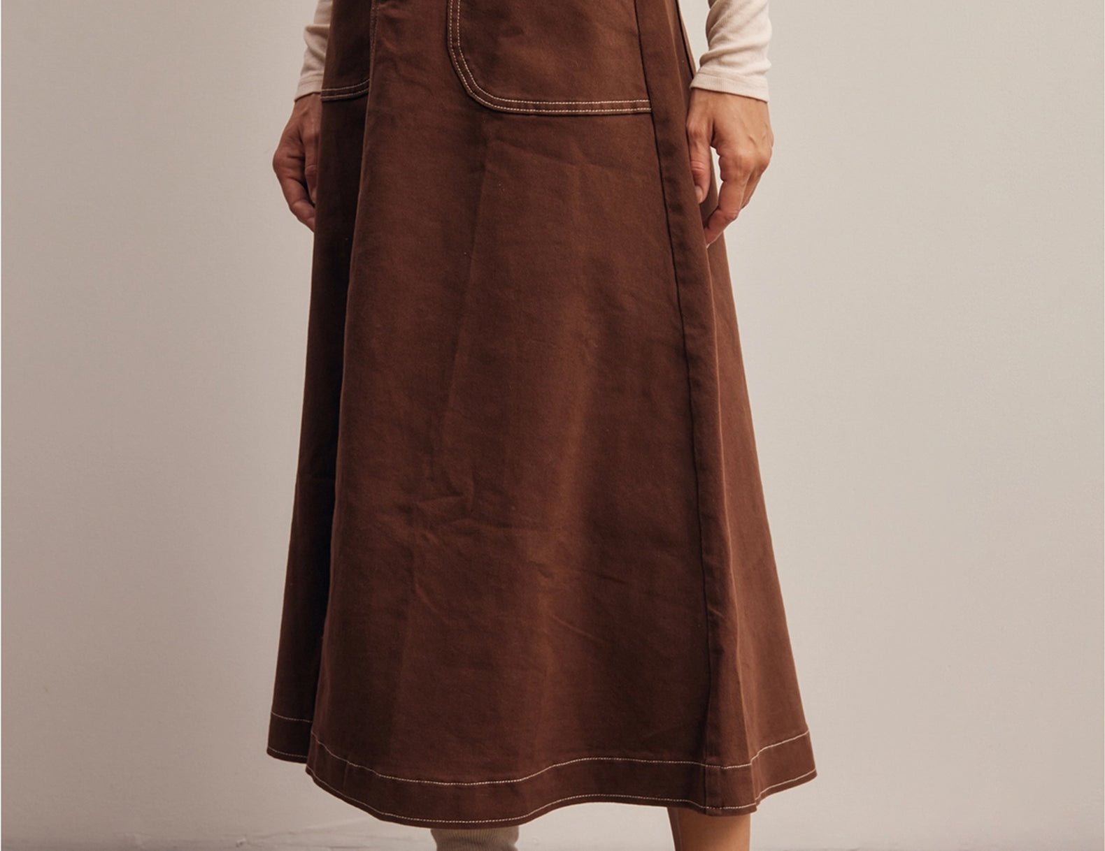 Side angle of the Shilo midi skirt showing the A-line flare and topstitched hem