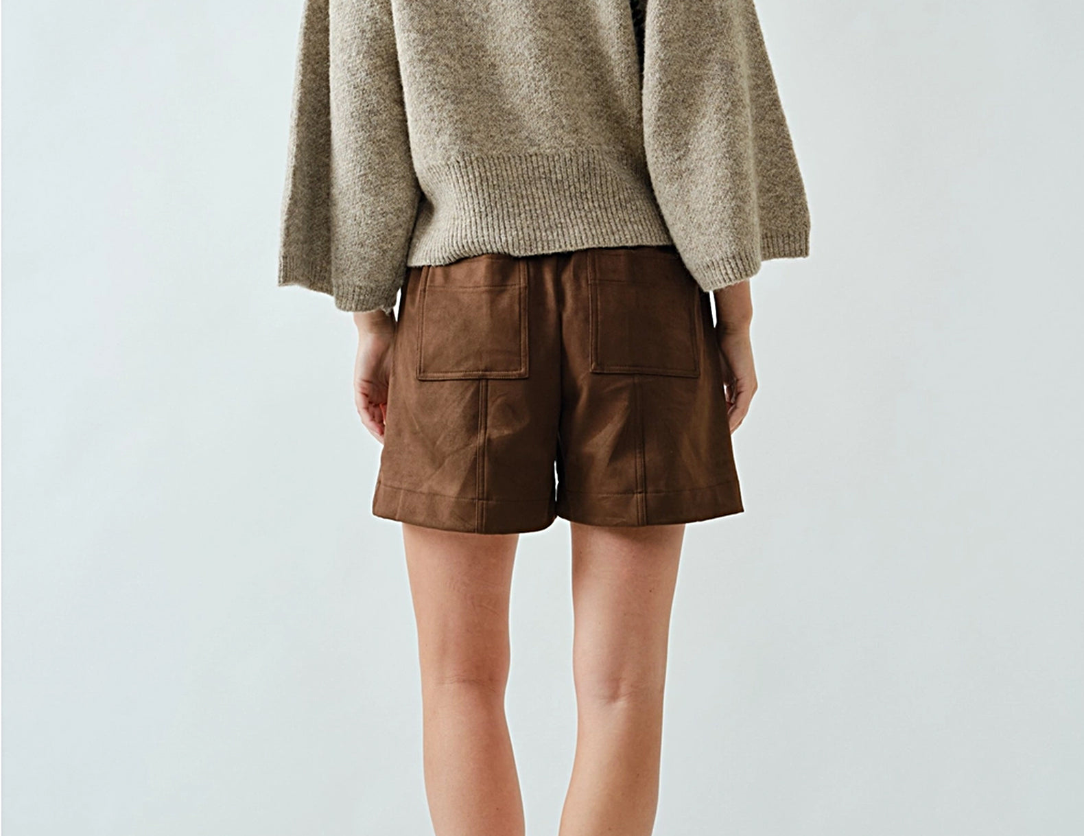 Oatmeal raglan sweater, back view styled with shorts and loafers